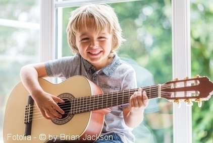 Kid playing guitar