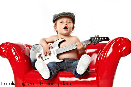 toddler with toy guitar